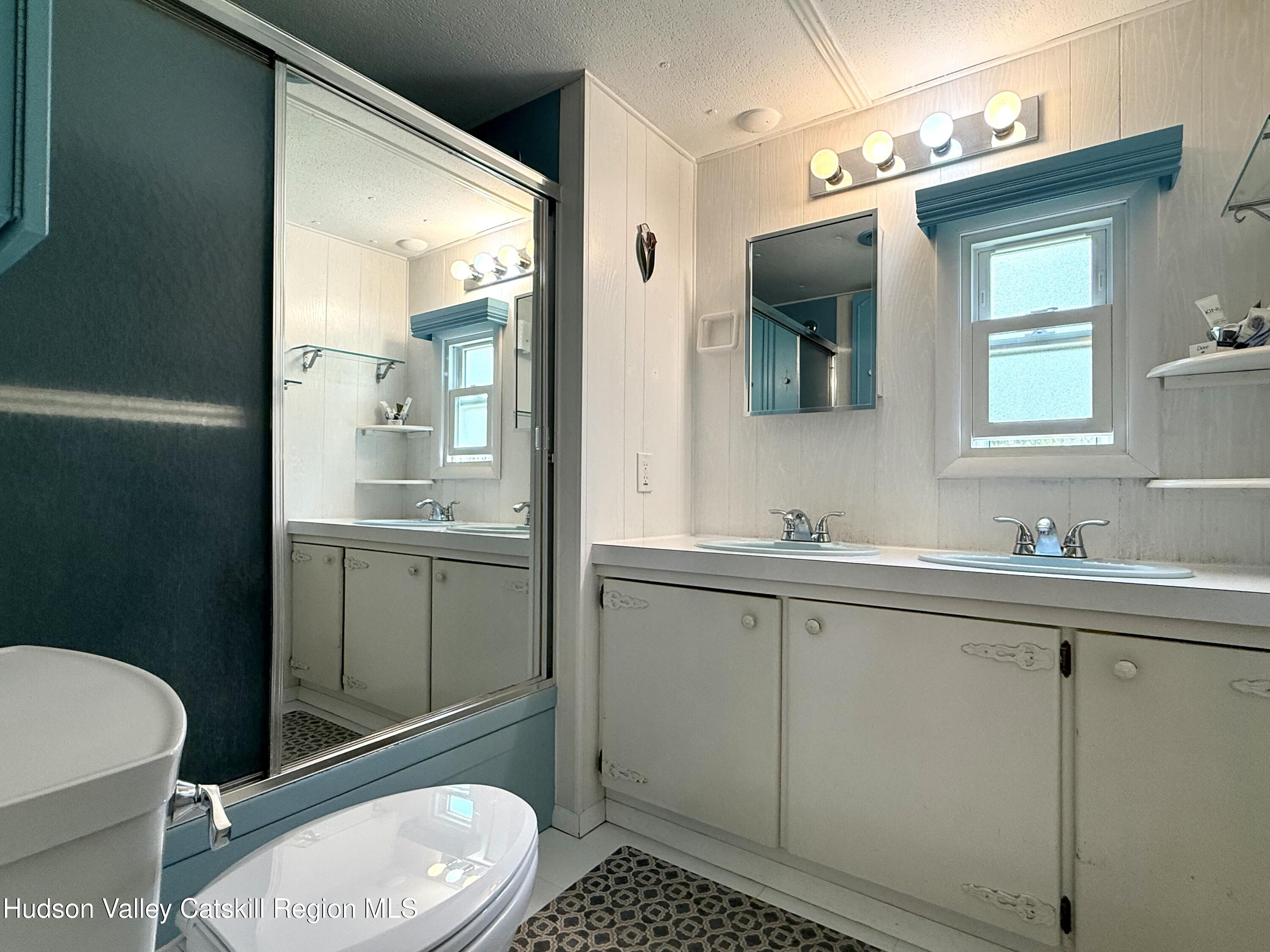 221 Colgate Road East Jewett, NY 12424 - Photo 18 of 34 a bathroom with a toilet a sink a mirror and vanity