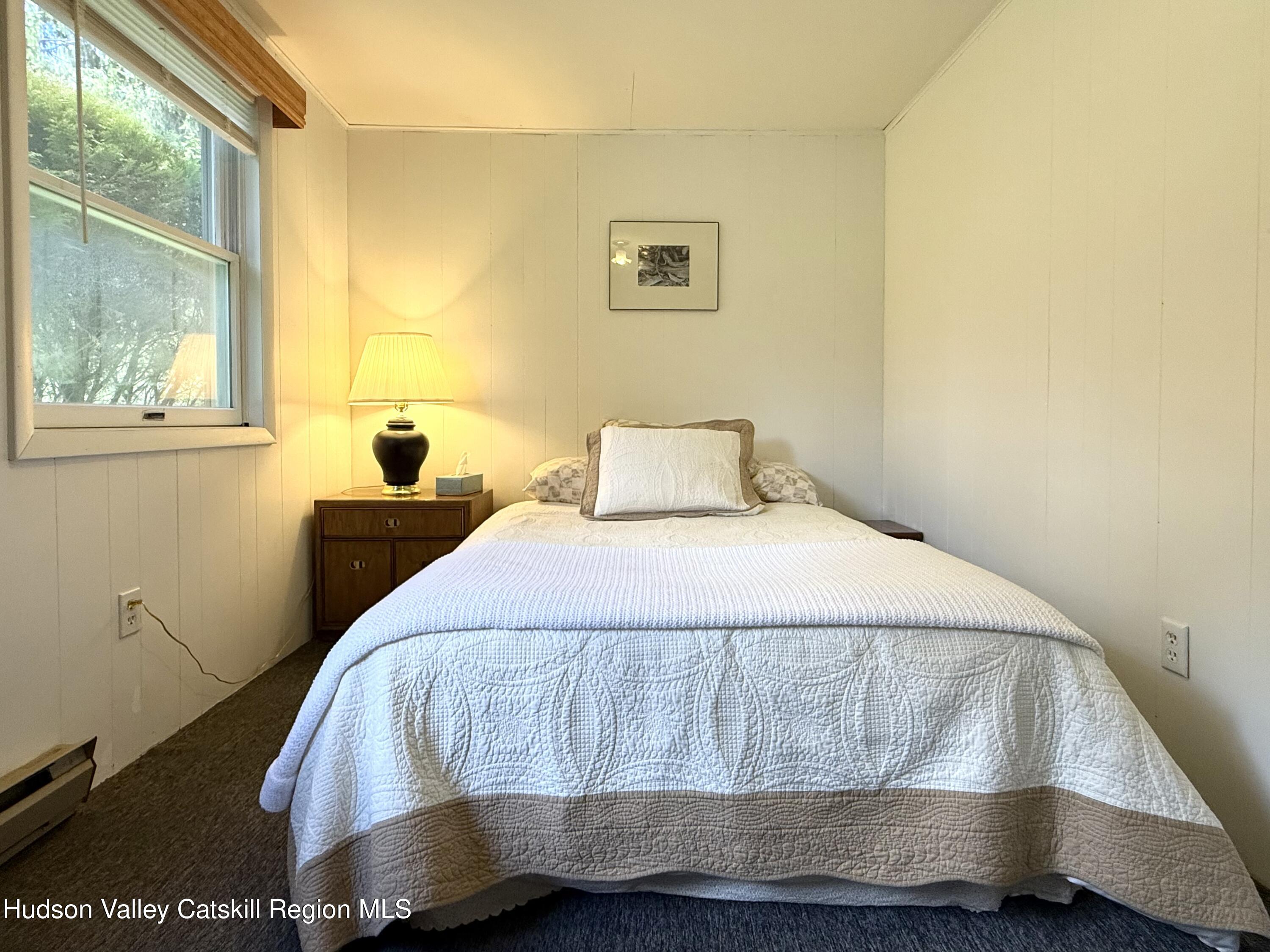 221 Colgate Road East Jewett, NY 12424 - Photo 22 of 34 a bedroom with a bed and window