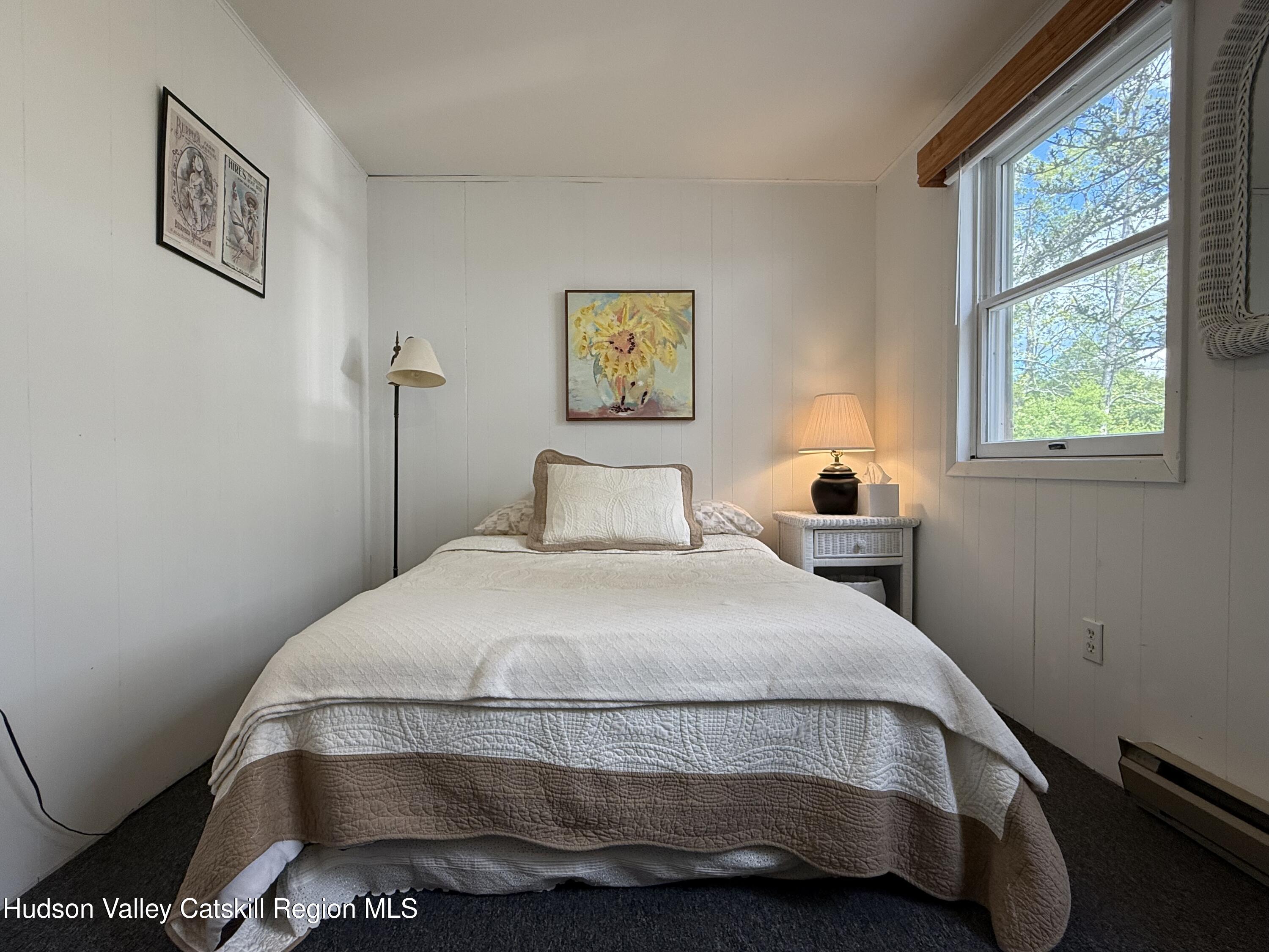 221 Colgate Road East Jewett, NY 12424 - Photo 25 of 34 a bedroom with a bed and a window