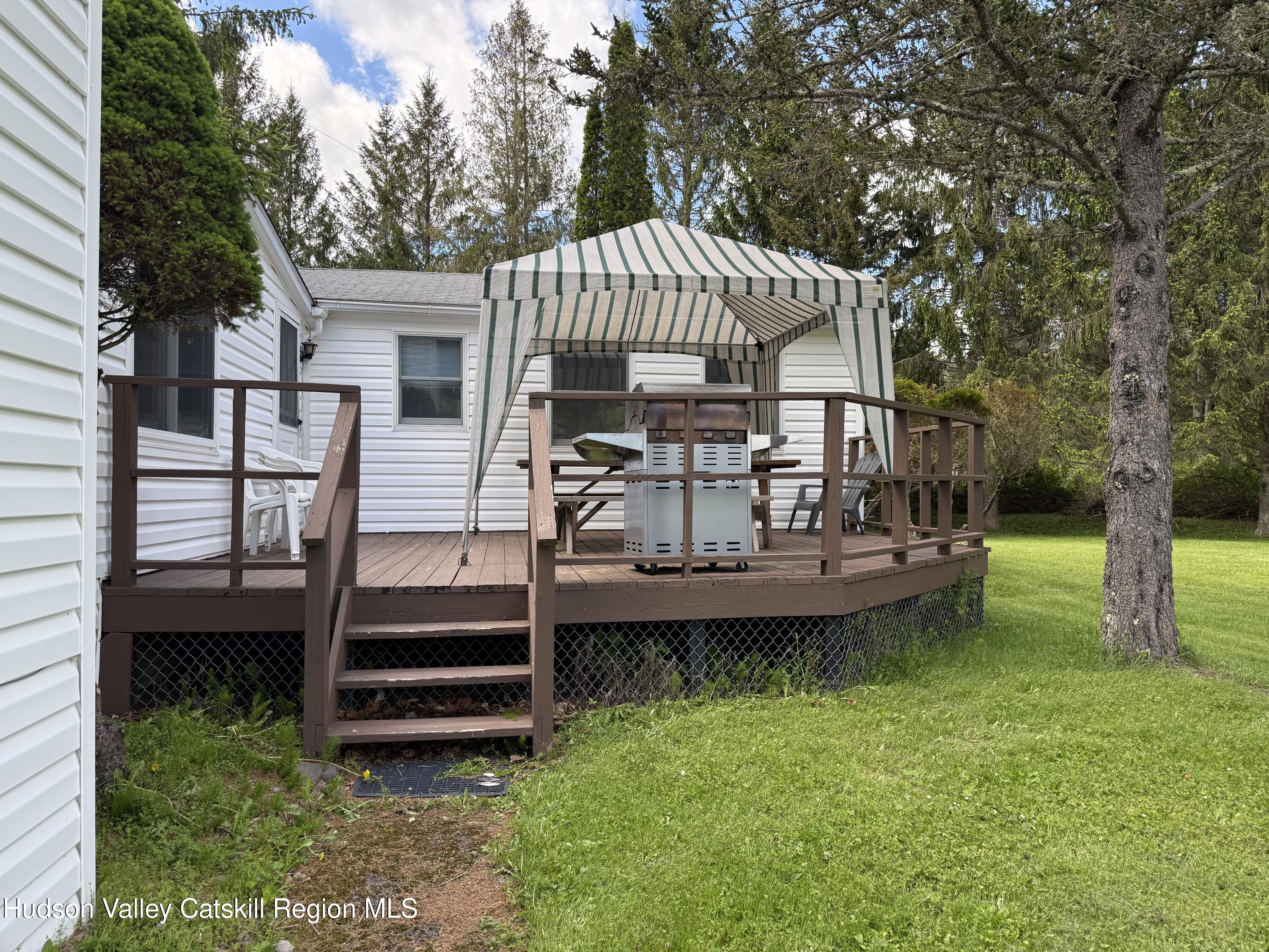 221 Colgate Road East Jewett, NY 12424 - Photo 28 of 34 a view of a house with a yard deck and a small cabin
