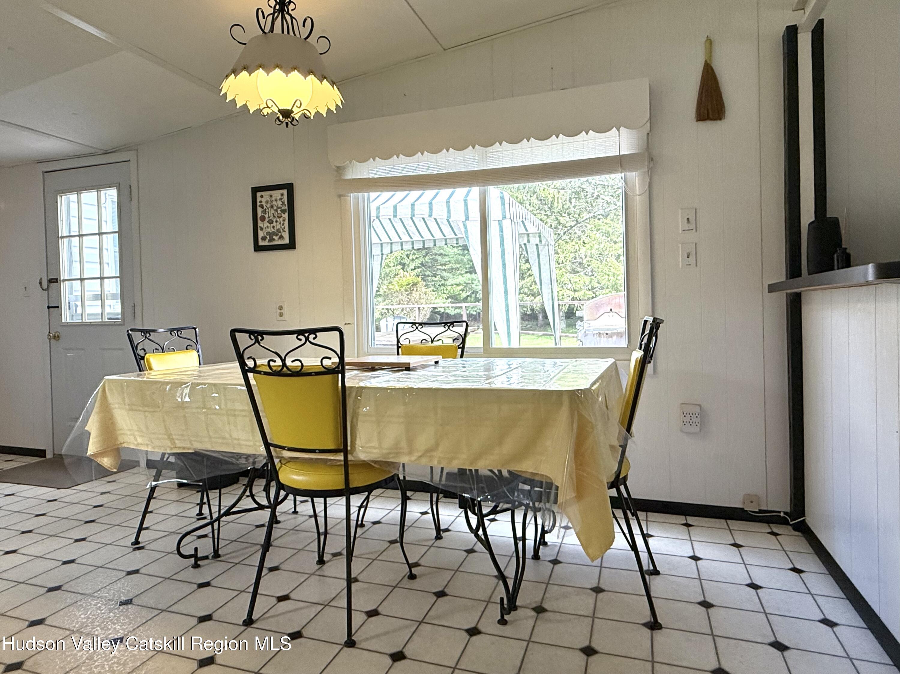 221 Colgate Road East Jewett, NY 12424 - Photo 9 of 34 a view of a dining room with furniture and a chandelier
