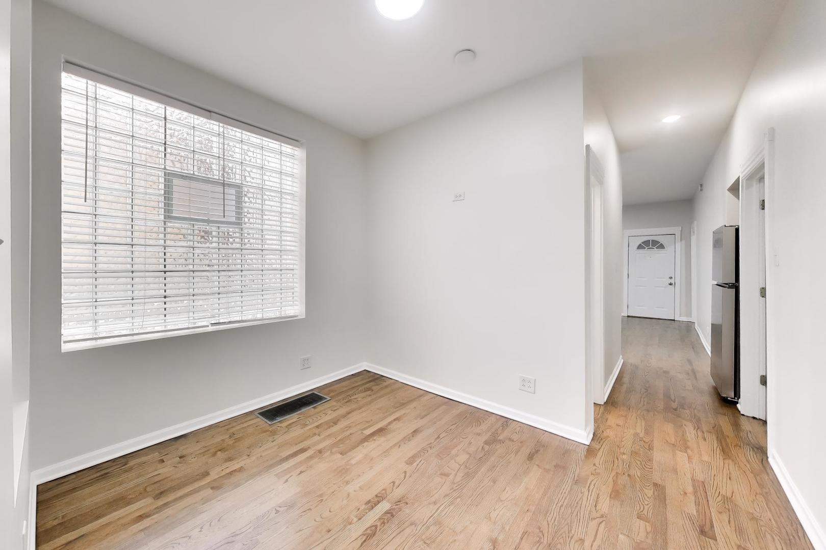 2135 West Division Street, Unit 1R Chicago, IL 60622 - Photo 7 of 12 a view of empty room with wooden floor and fan
