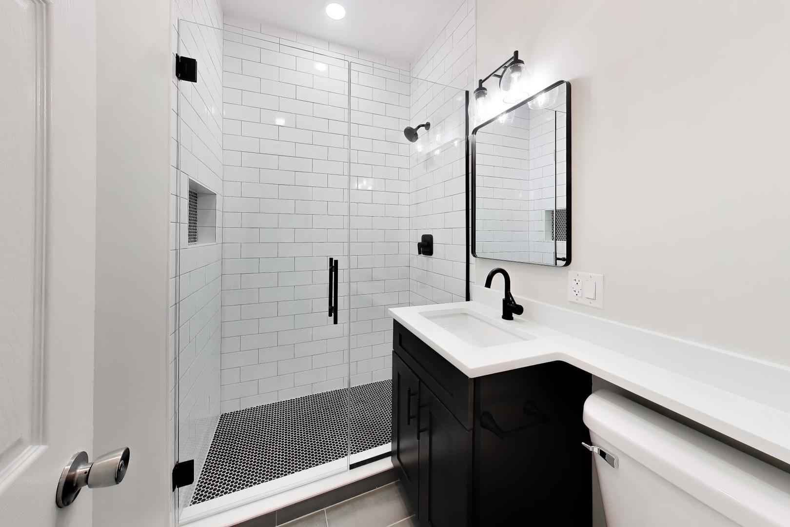2135 West Division Street, Unit 1R Chicago, IL 60622 - Photo 9 of 12 a bathroom with a sink a toilet and shower