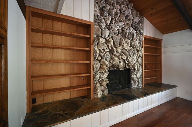 a view of wooden floor and a fireplace in a room