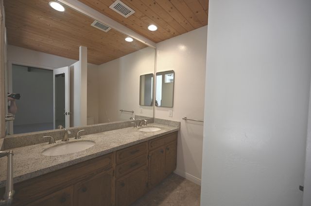 a bathroom with a double vanity sink and a mirror