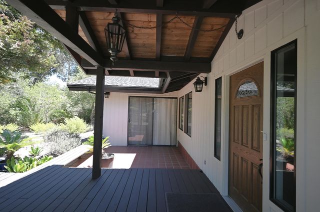 a view of hallway with wooden floor