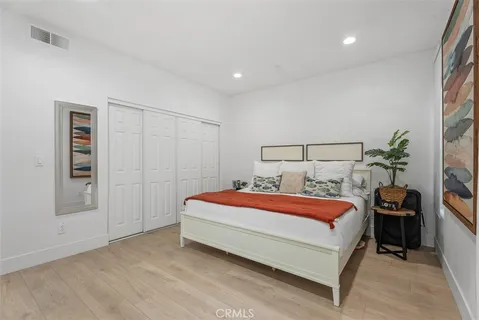 a bedroom with a bed and a potted plant