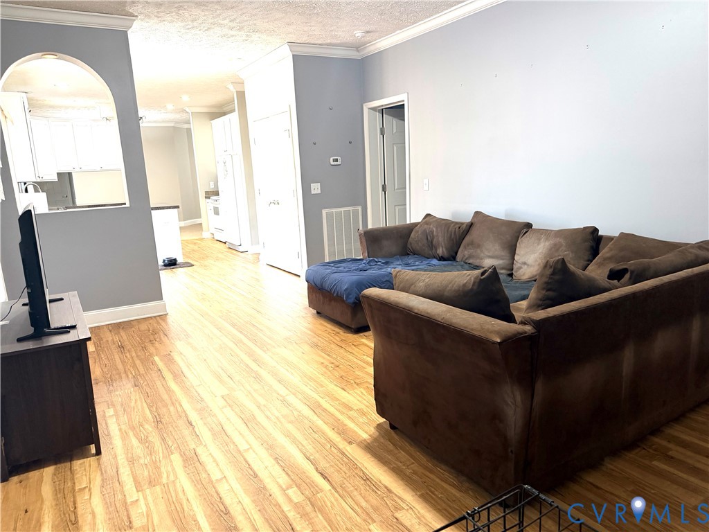 14558 Brick Road Petersburg, VA 23805 - Photo 13 of 27 Living area featuring crown molding, light wood-ty