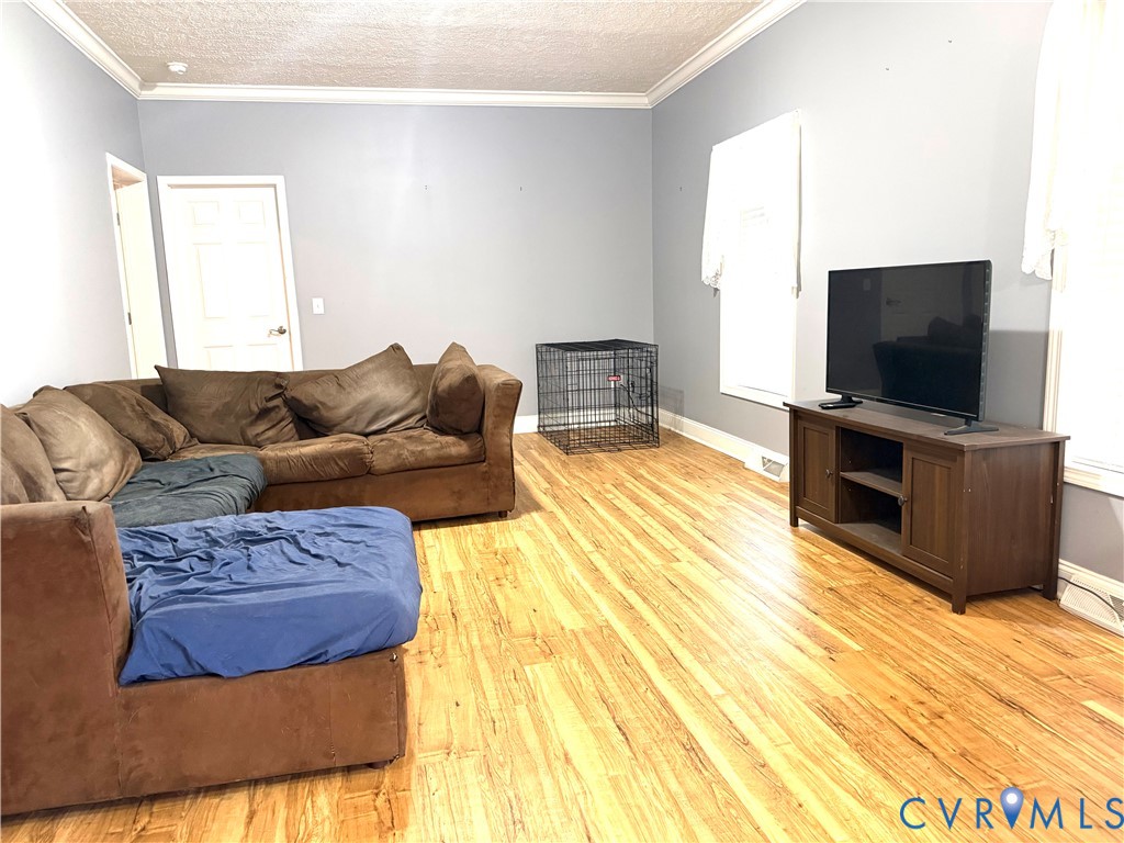 14558 Brick Road Petersburg, VA 23805 - Photo 14 of 27 Living area with ornamental molding, light wood fi