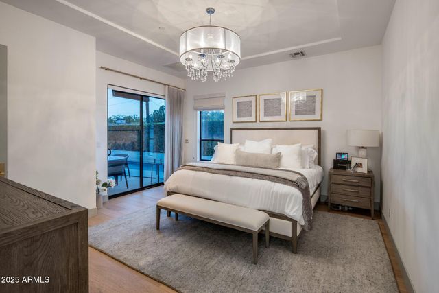 a bed room with a bed and a chandelier