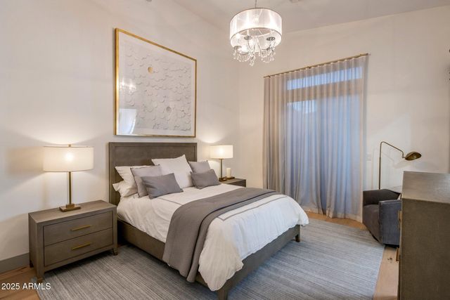 a bedroom with bed and wooden floor