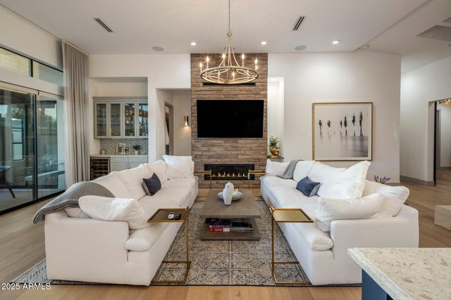 a living room with furniture a fireplace and a flat screen tv