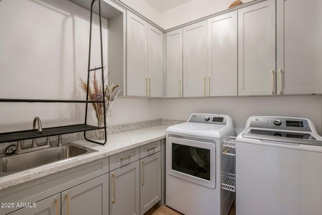 a kitchen with a sink a stove and cabinets