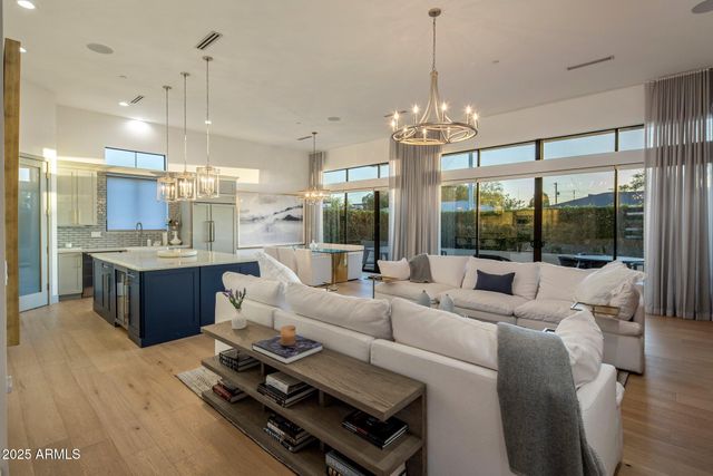 a living room with furniture a chandelier and a chandelier
