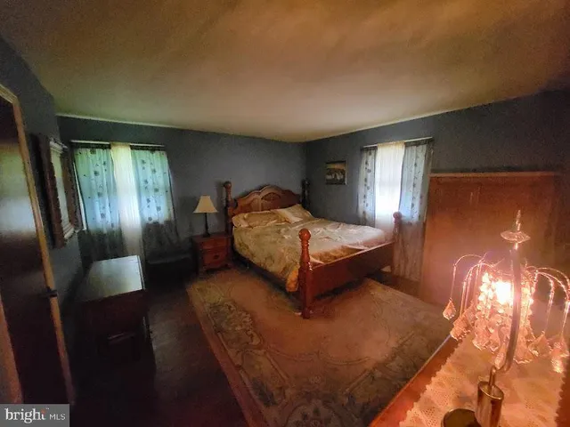 a bedroom with a bed and window with lamp
