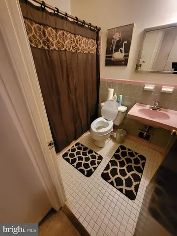 a bathroom with a sink a toilet and a shower