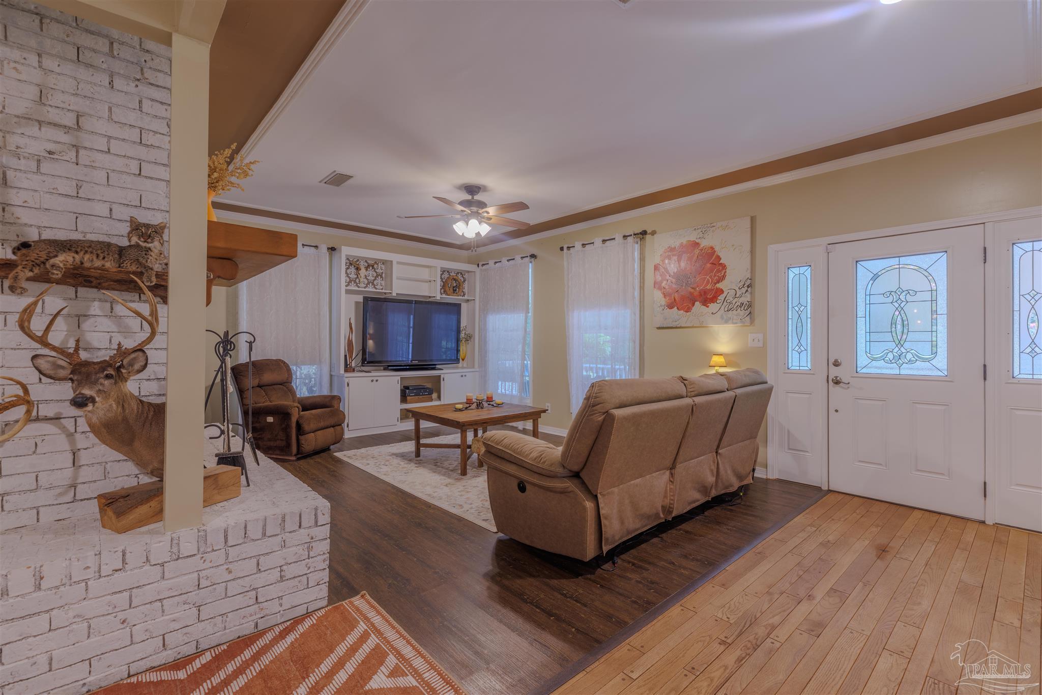 5049 Guernsey Road Pace, FL 32571 - Photo 18 of 61 a living room with furniture and a wooden floor