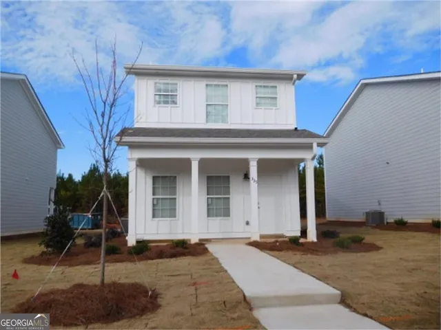a front view of a house with garden