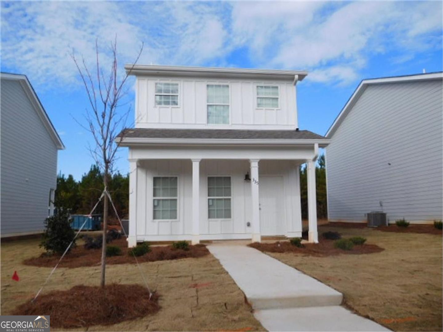 a front view of a house with garden