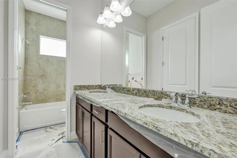 a view of a house with snow on the road