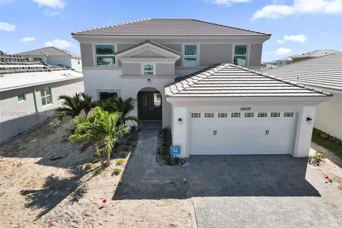 an aerial view of a house with a ocean view