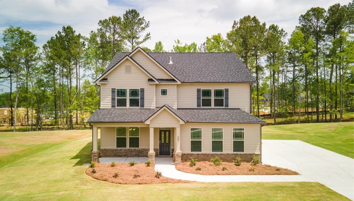409 Beachview Road, Unit 42 Hampton, GA 30228 - Photo 1 of 1 a front view of a house with a yard
