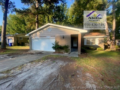733 Goodyear Drive Spring Lake, NC 28390 - Photo 1 of 13 a front view of a house with a yard and garage