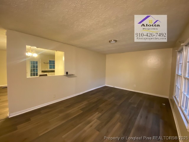 733 Goodyear Drive Spring Lake, NC 28390 - Photo 2 of 13 a view of an empty room with wooden floor and a window