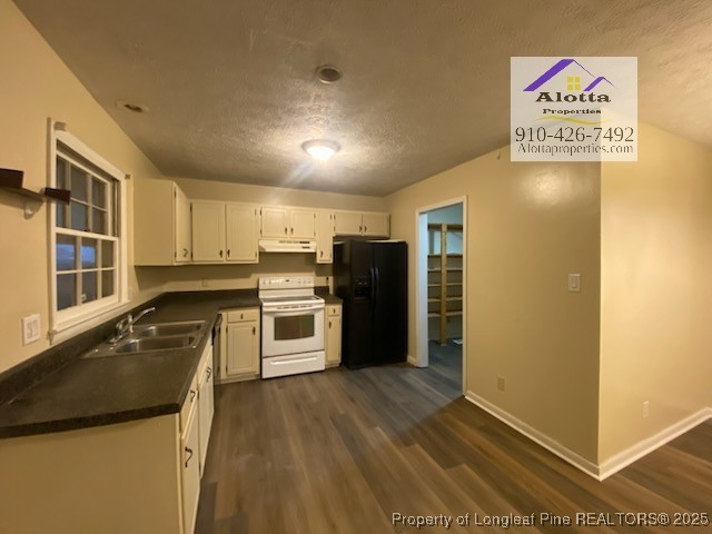 733 Goodyear Drive Spring Lake, NC 28390 - Photo 5 of 13 a kitchen with granite countertop a refrigerator and a sink