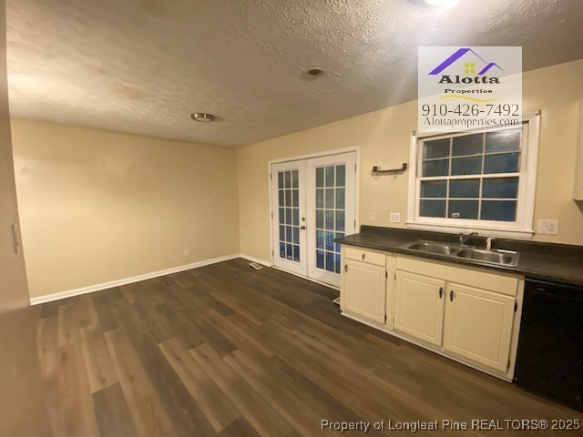 733 Goodyear Drive Spring Lake, NC 28390 - Photo 6 of 13 a large white kitchen with granite countertop a sink and dishwasher stove with wooden floor