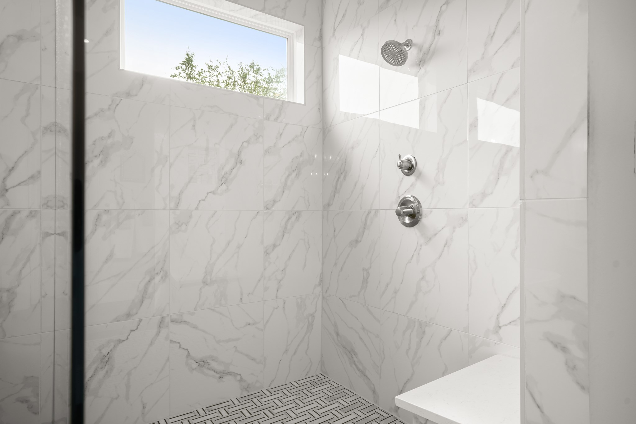 104 Lodestone Cove Austin, TX 78738 - Photo 21 of 40 A well-appointed shower with elegant tile work and a convenient built-in bench.