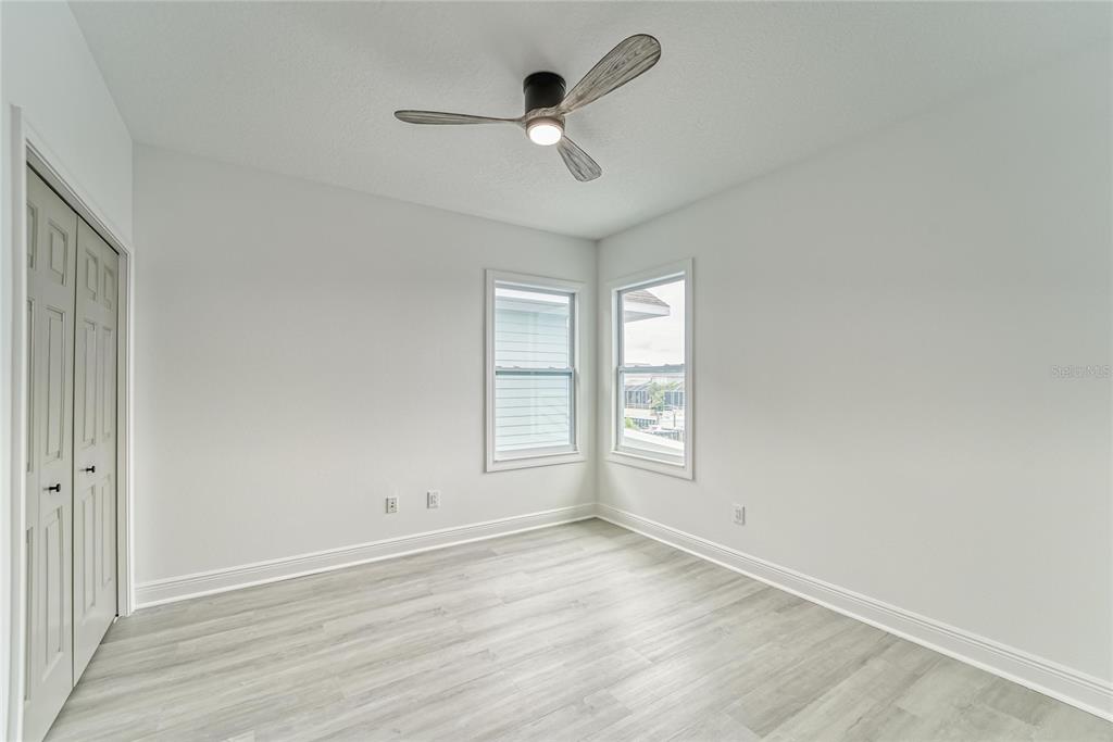 5718 Sea Turtle Place Apollo Beach, FL 33572 - Photo 11 of 81 an empty room with wooden floor and ceiling fan