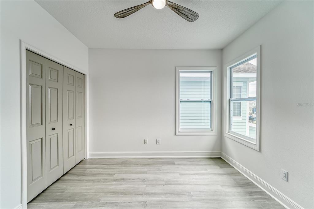 5718 Sea Turtle Place Apollo Beach, FL 33572 - Photo 12 of 81 a view of an empty room with wooden floor and a window