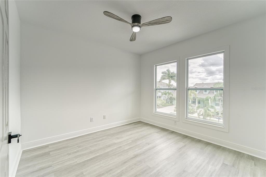 5718 Sea Turtle Place Apollo Beach, FL 33572 - Photo 19 of 81 a view of an empty room with a window and wooden floor