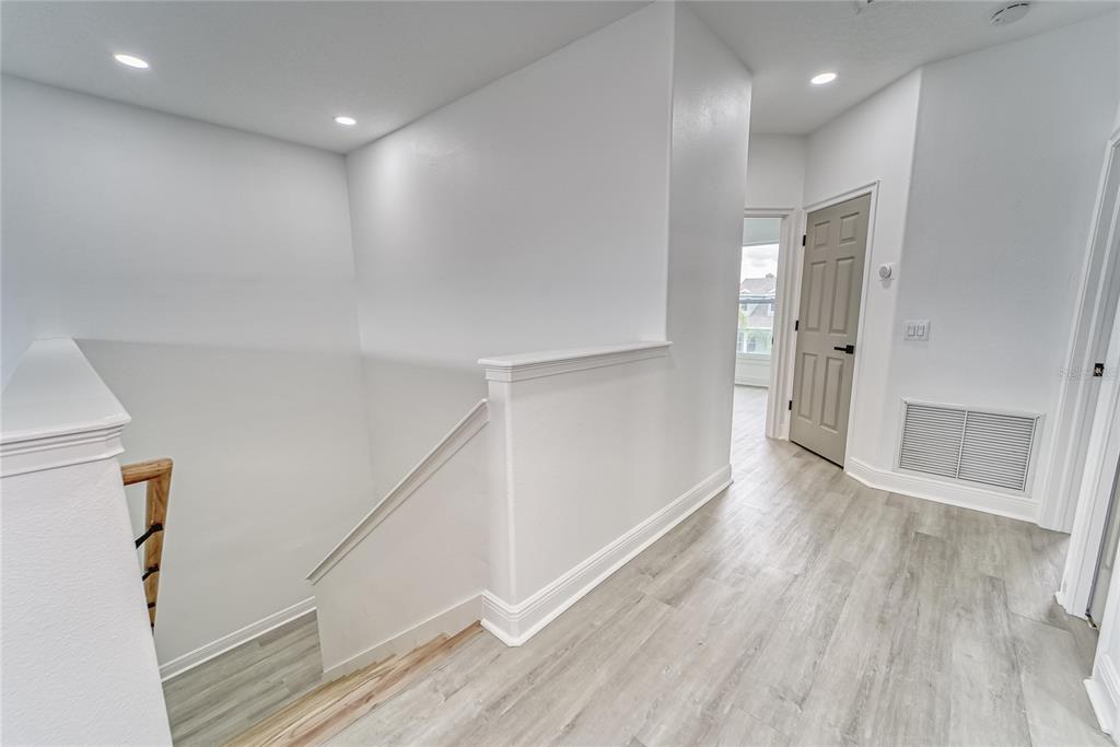 5718 Sea Turtle Place Apollo Beach, FL 33572 - Photo 30 of 81 a view of hallway with stairs and wooden floor