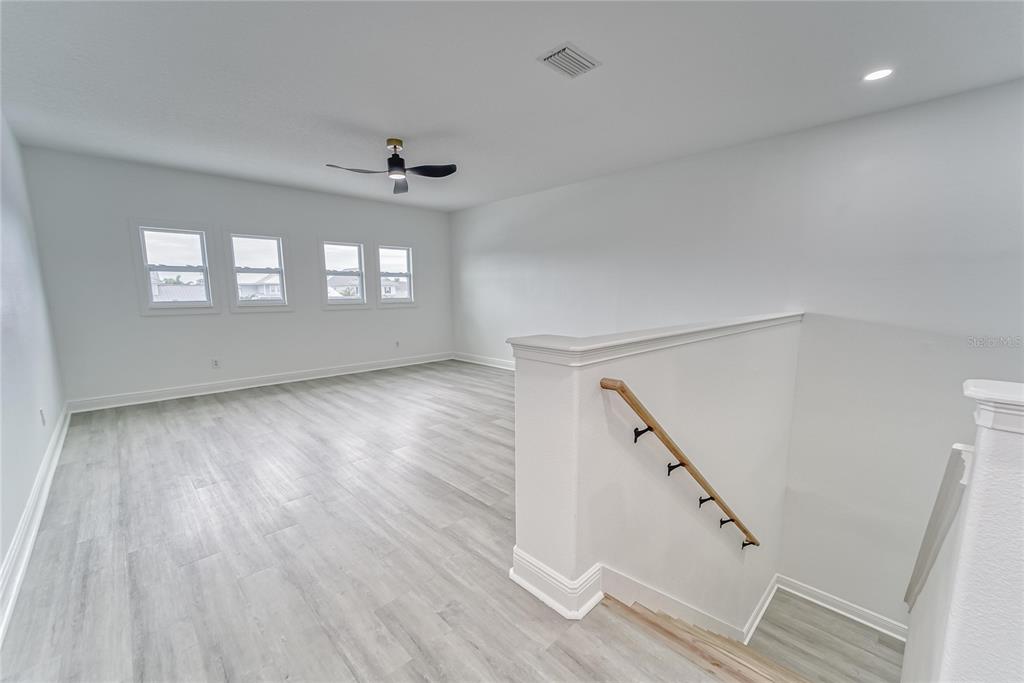 5718 Sea Turtle Place Apollo Beach, FL 33572 - Photo 31 of 81 wooden floor in an empty room with a window