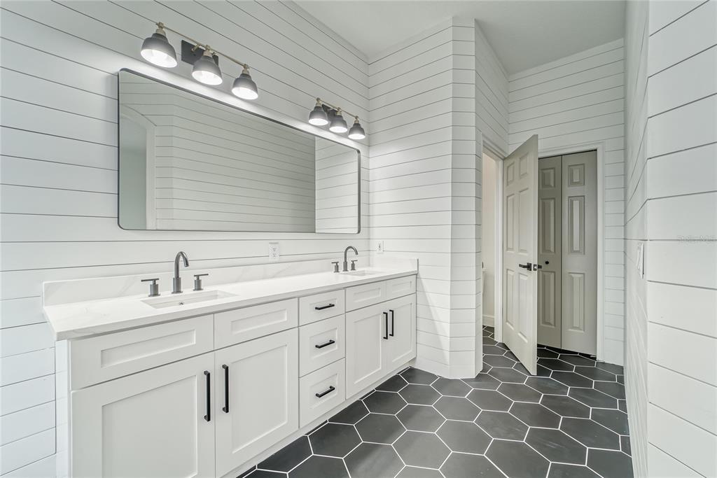 5718 Sea Turtle Place Apollo Beach, FL 33572 - Photo 48 of 81 a bathroom with a double vanity sink and a mirror