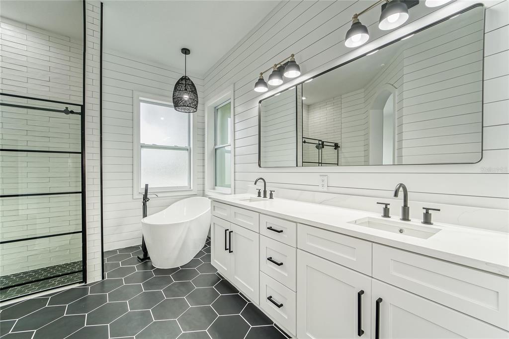 5718 Sea Turtle Place Apollo Beach, FL 33572 - Photo 50 of 81 a spacious bathroom with a double vanity sink mirror and a bathtub