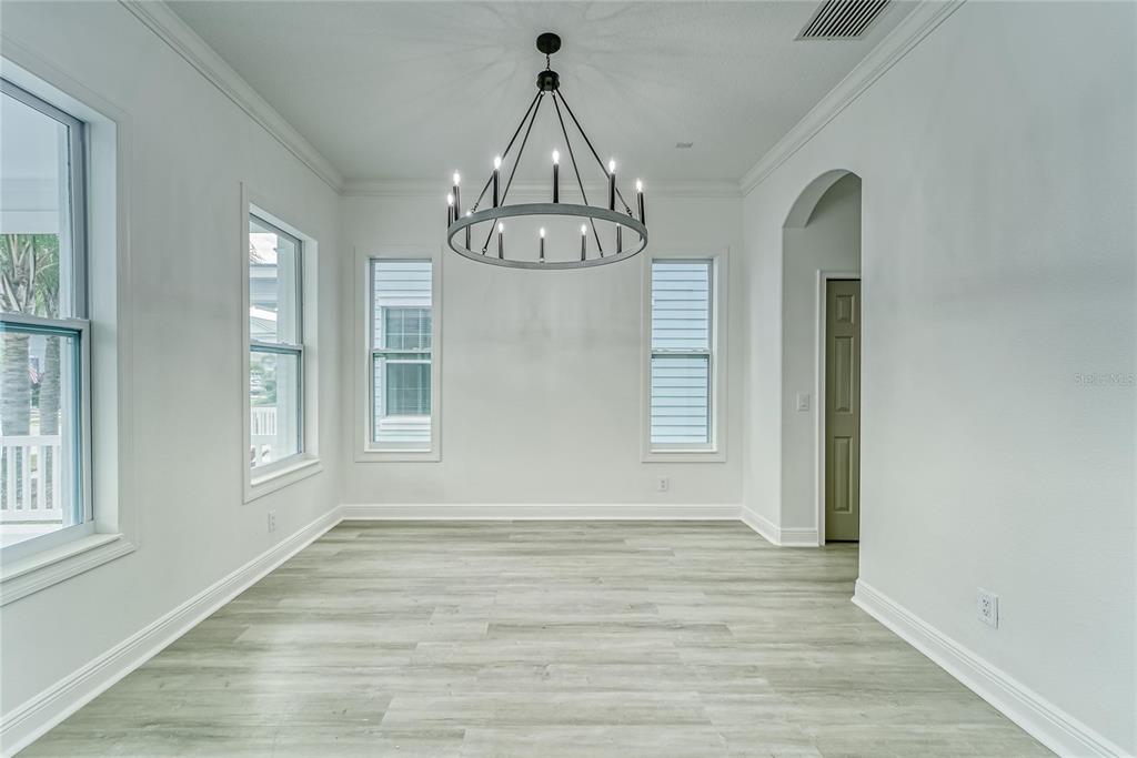 5718 Sea Turtle Place Apollo Beach, FL 33572 - Photo 54 of 81 a view of a room with wooden floor chandelier and windows