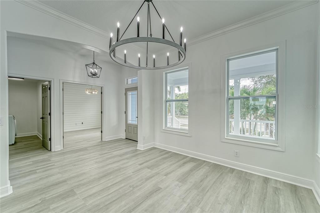 5718 Sea Turtle Place Apollo Beach, FL 33572 - Photo 56 of 81 an empty room with wooden floor chandelier and glass door