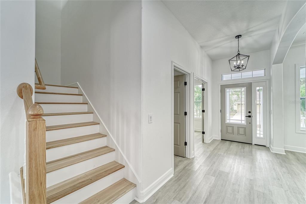 5718 Sea Turtle Place Apollo Beach, FL 33572 - Photo 59 of 81 a view of a hallway with wooden floor and entryway