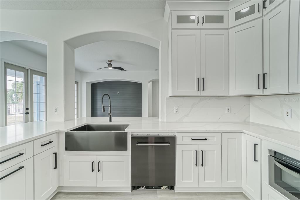5718 Sea Turtle Place Apollo Beach, FL 33572 - Photo 72 of 81 a kitchen with stainless steel appliances white cabinets and a sink