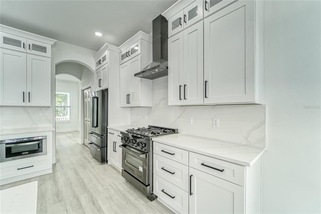5718 Sea Turtle Place Apollo Beach, FL 33572 - Photo 75 of 81 a kitchen with white cabinets and white appliances