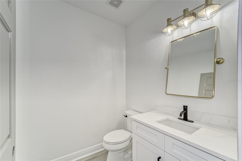 5718 Sea Turtle Place Apollo Beach, FL 33572 - Photo 79 of 81 a bathroom with a sink a toilet and a mirror