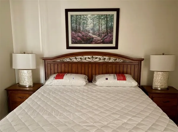 a bedroom with a bed and a lamp on table