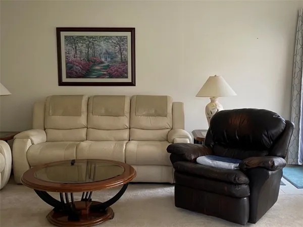 a living room with furniture and a lamp