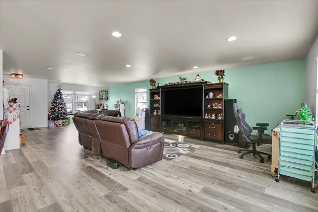 a living room with furniture a flat screen tv and a fireplace