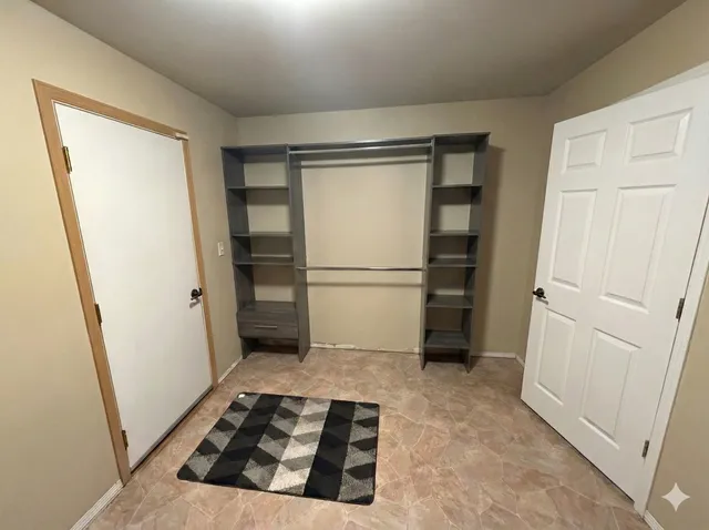 a view of a kitchen with a refrigerator and cabinets