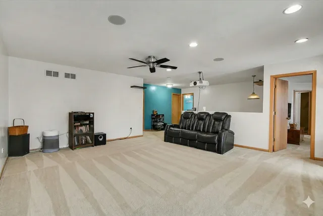 a large bedroom with a bed and a chandelier