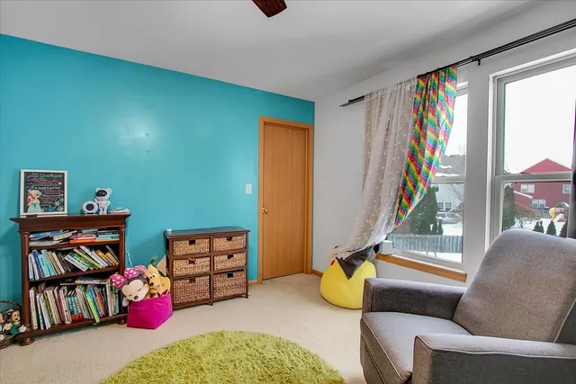 a living room with furniture a rug and a window